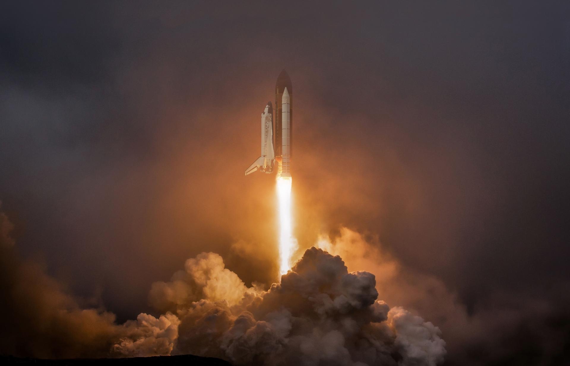 Rocket liftoff. Shuttle spaceship launch in the clouds sky. Spaceship begins the mission. Space shuttle taking off on a mission. Concept space travel to mars